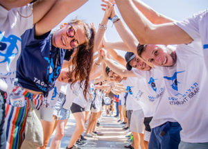 Birthright Israel participants forming a tunnel with their arms