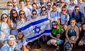 A Birthright Israel group holding up an Israeli flag