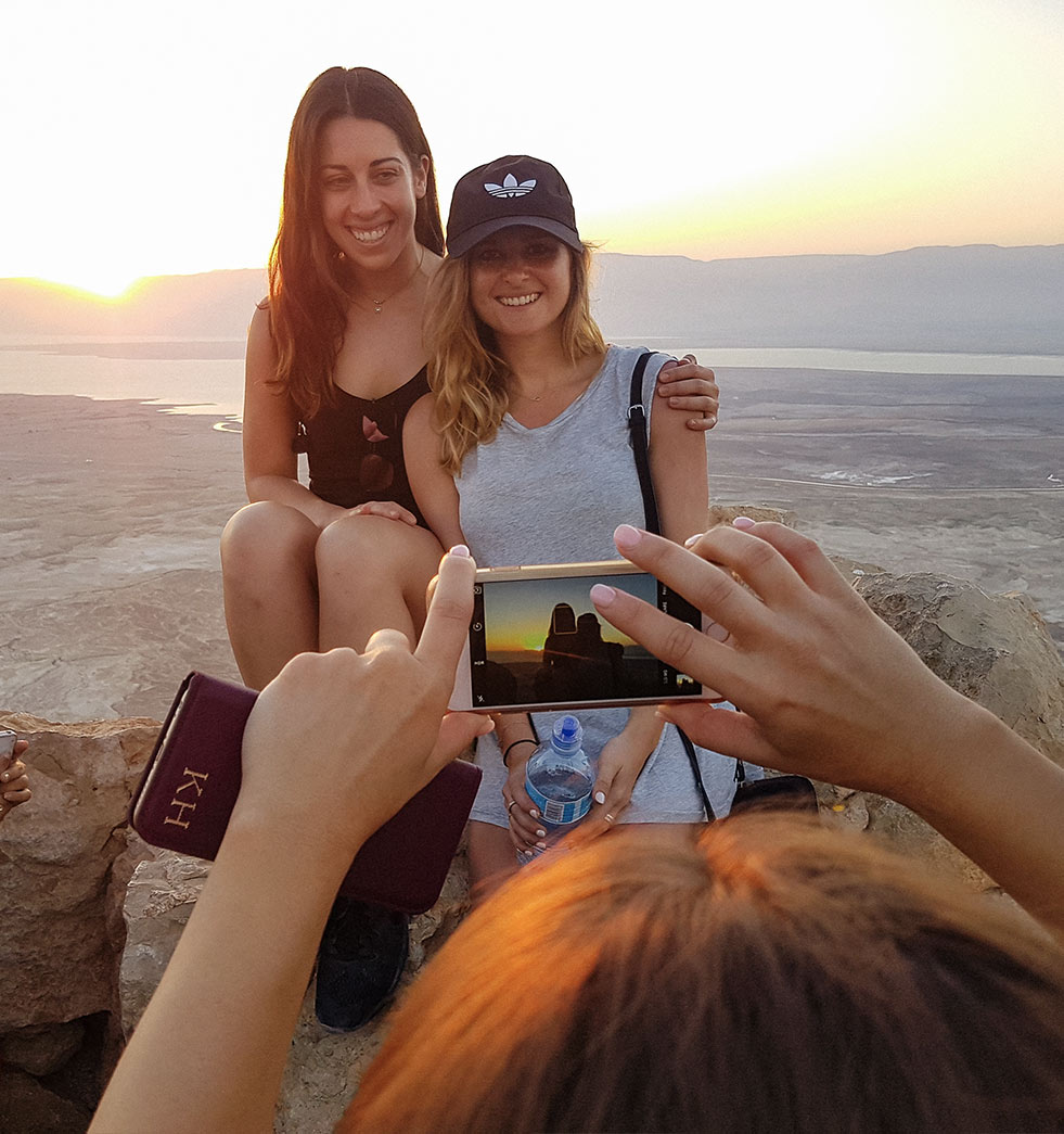 Taking a photo of a couple of Birthright Israel participants at sunrise on Masada
