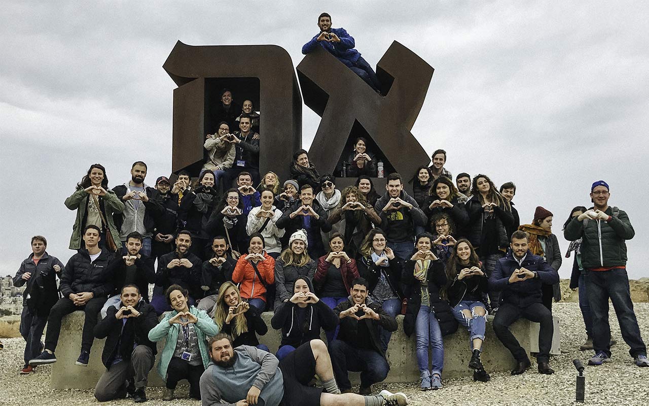 Jared Sapolsky's Birthright Israel group in front of the Ahava sign