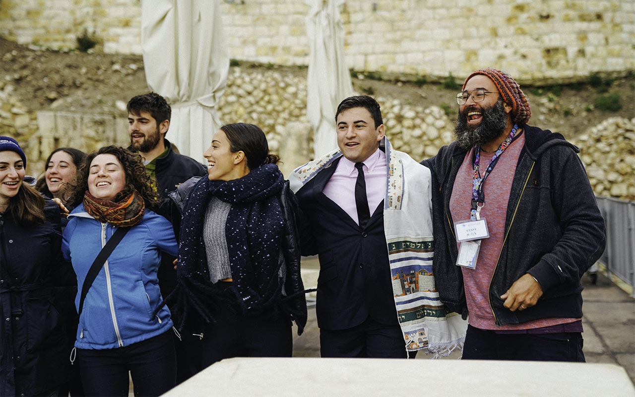 Matthew Labkovski celebrating with members of his Birthright Israel group as they become Bar and Bat Mitzvah at the Kotel