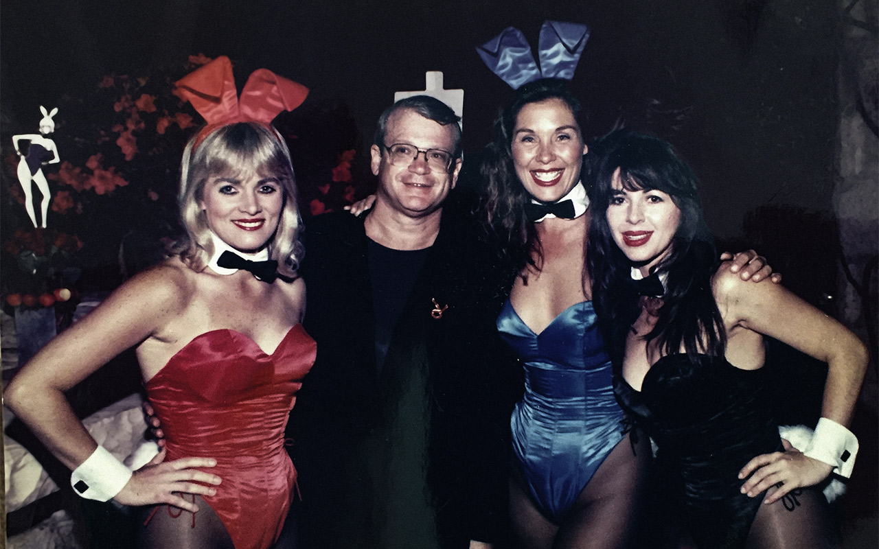 Robert Beleson with three Playboy bunnies during his time as Director of Marketing for the company 