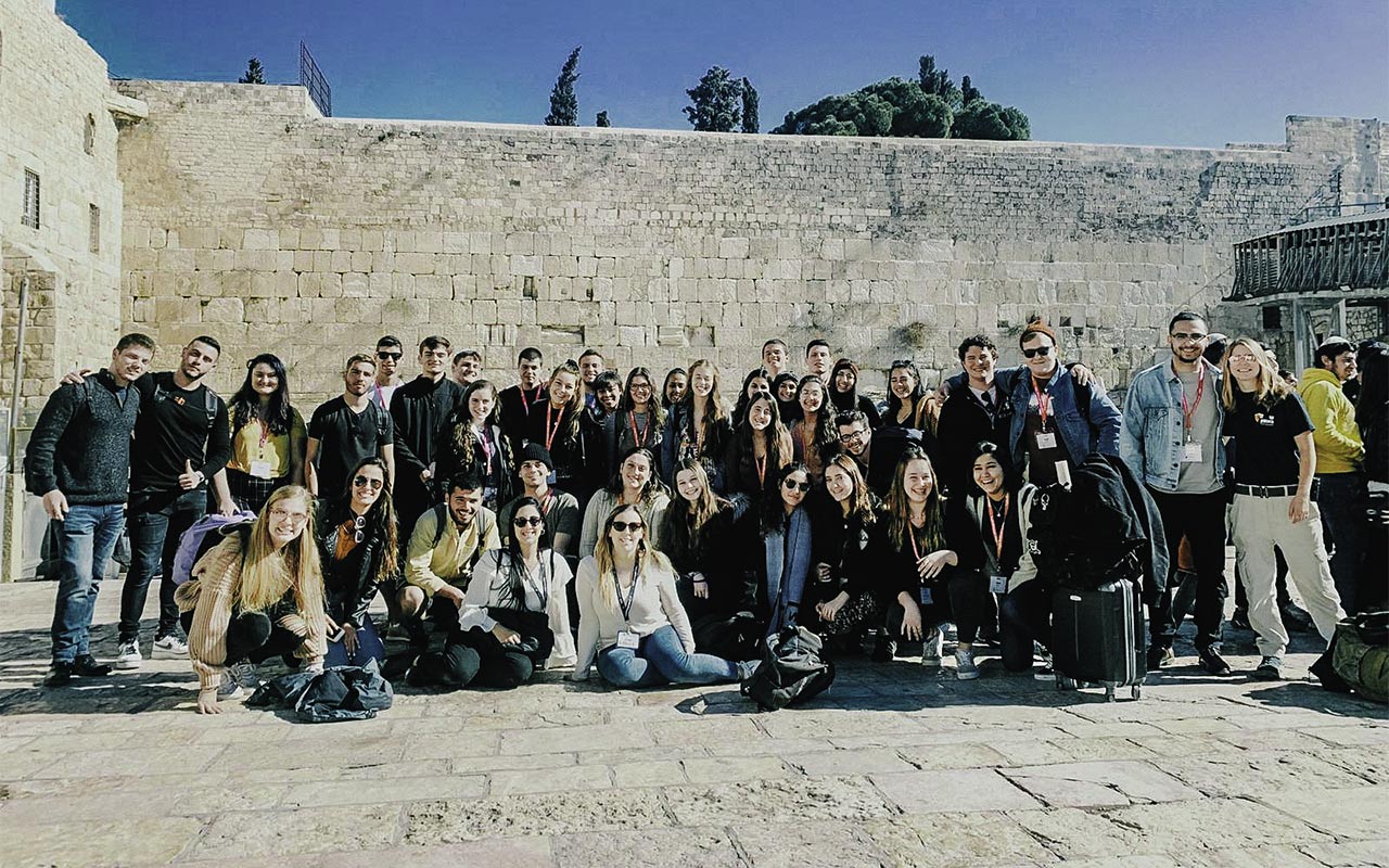 Snir Lasri with his Birthright Israel group at the Kotel in 2019