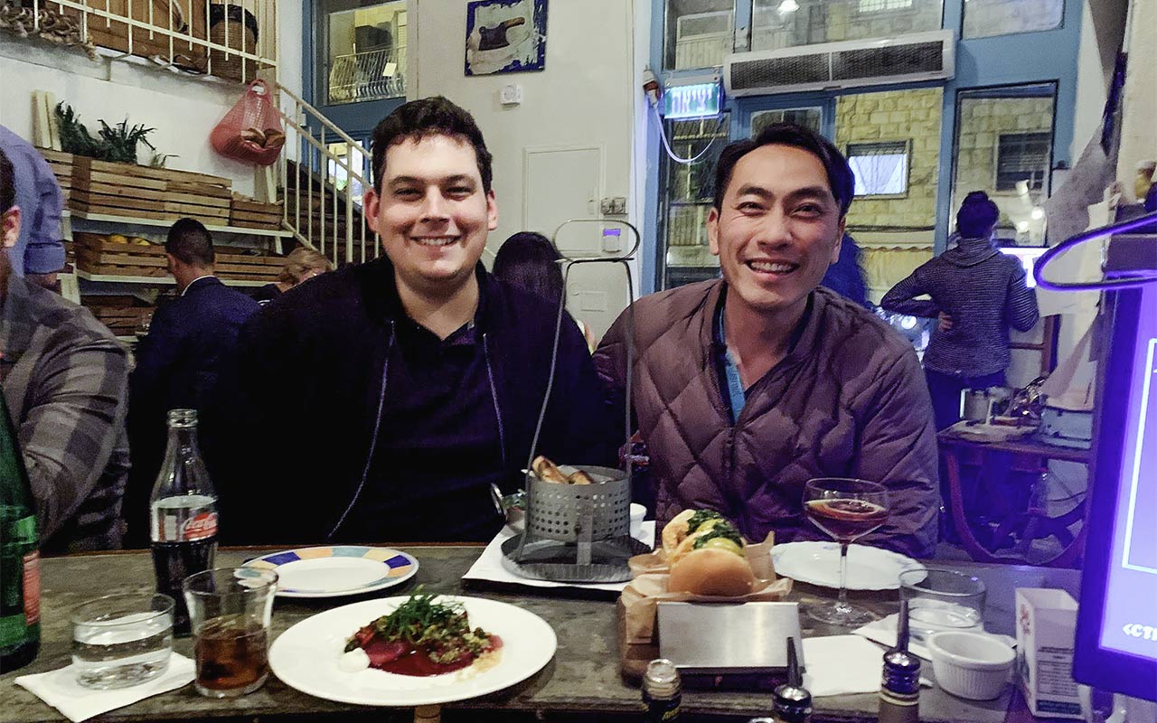 Alex Lin-Goldsmith at dinner with his husband Danny on their Birthright Israel trip