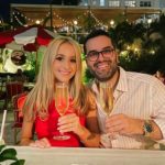 Birthright Israel alumni Lindsay Kaufman & Mike Serviansky holding champagne at their engagement dinner