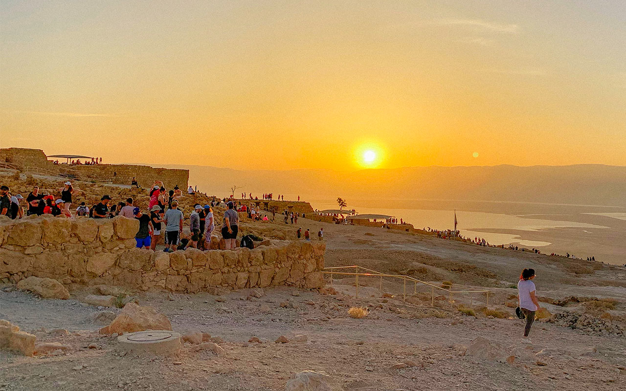 Jeremy Ettlinger's photo of his group resting after a hike on top of Masada at sunrise