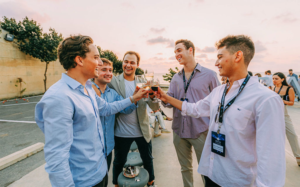 Isaac Goldman sharing a drink at sunset with members of his Birthright Israel group